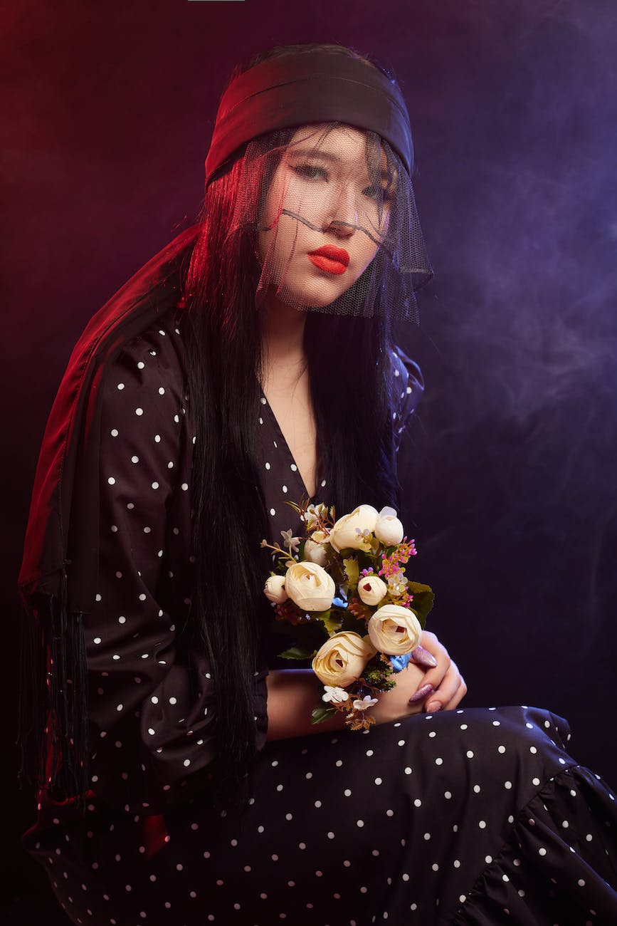 Why Do I Feel Guilty? Understanding the Emotion and Ways to Overcome it 1 woman in black and white polka dot dress holding bouquet of flowers