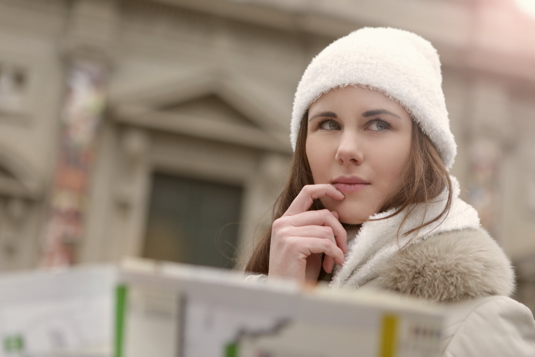 Why Are Flights So Expensive? The Truth Behind Airfare Prices 5 young lady in warm wear thinking in city street